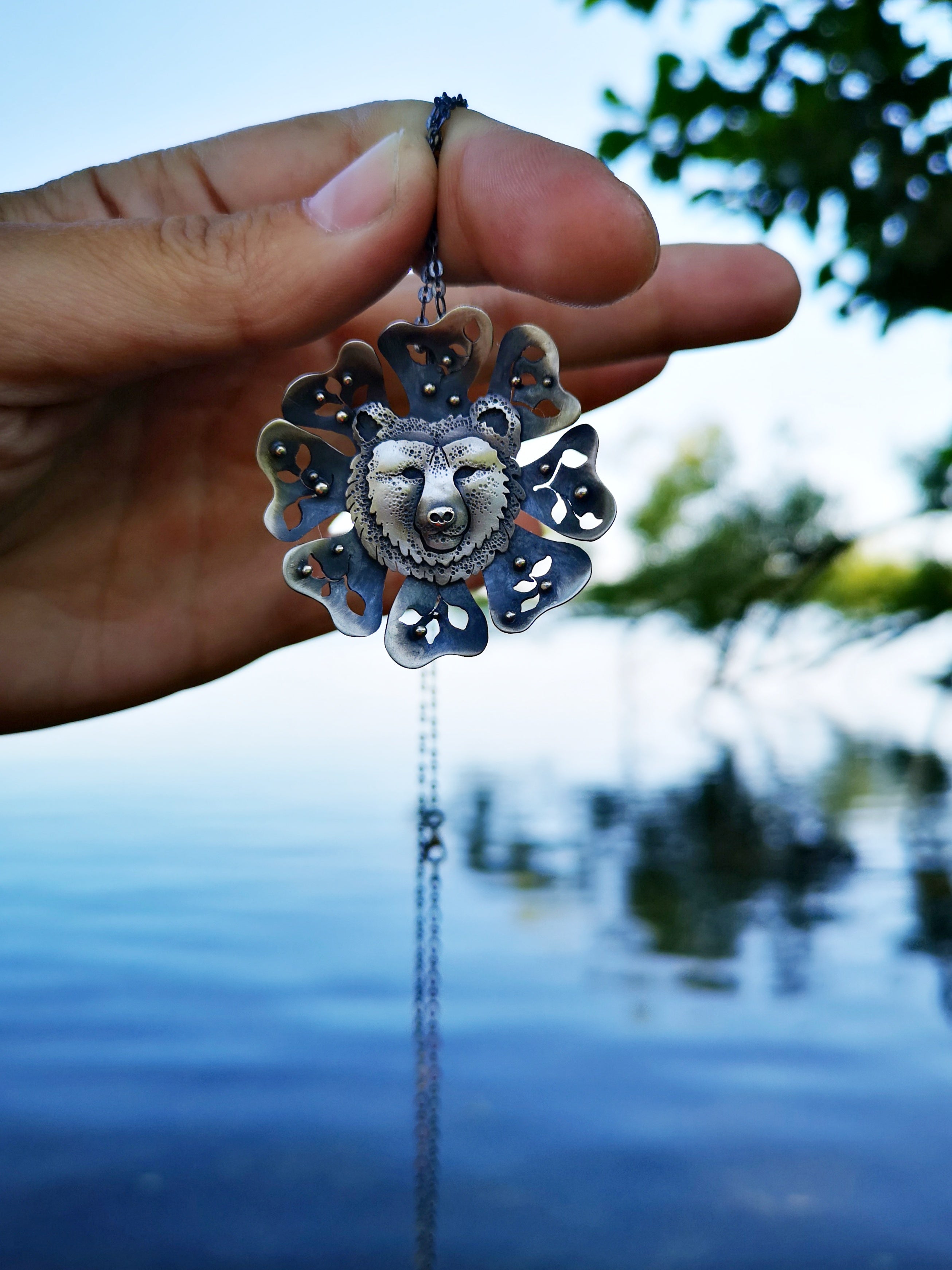 Bear-shaped wooden totem pendant with gemstones on Craiyon